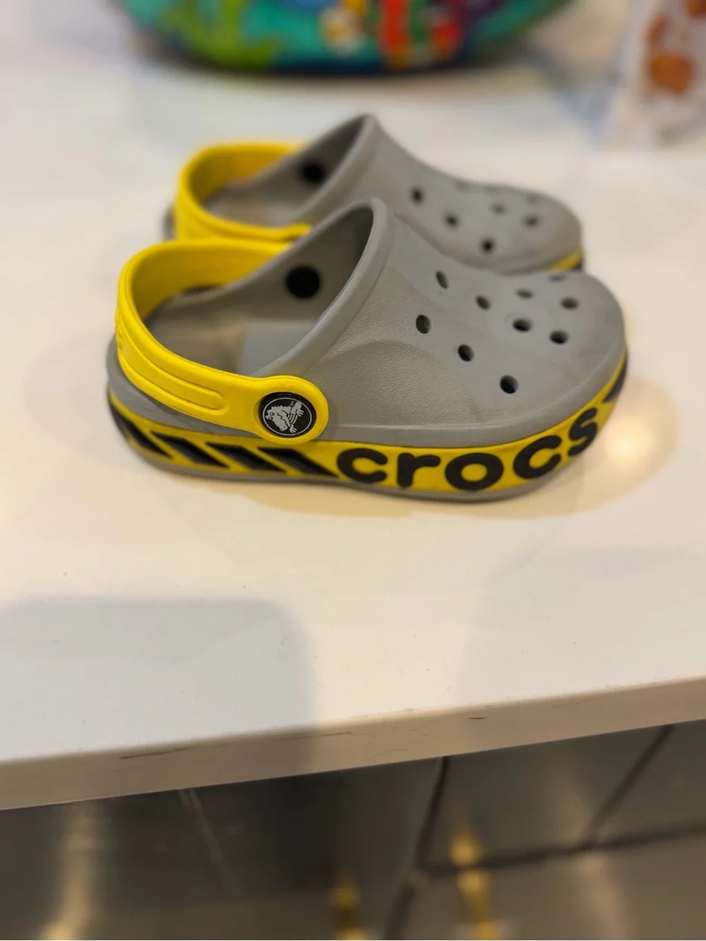 CROCS Kids Gray Clogs with Yellow Heel Strap